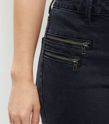 black jeans with zipper pockets