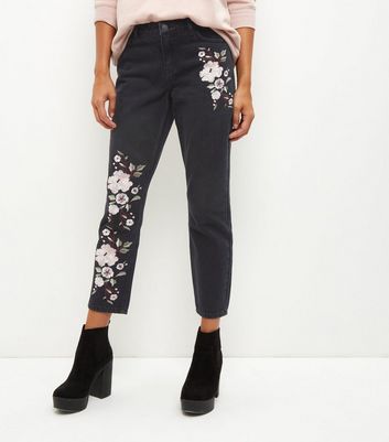 black jeans with floral embroidery