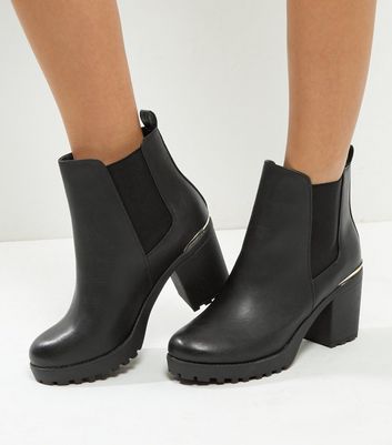 black boots with gold trim