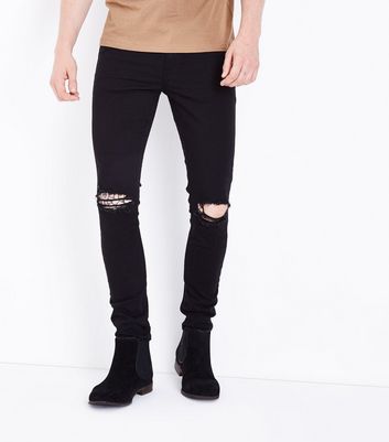 black ripped jeans at the knee