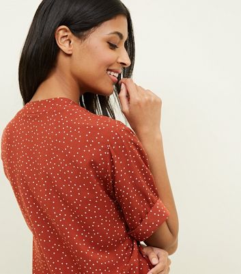 rust polka dot top