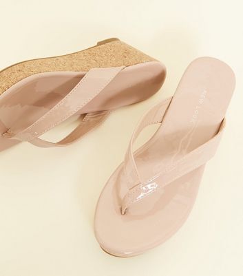 nude patent flip flops