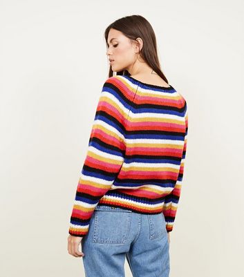 blue jumper with rainbow stripes