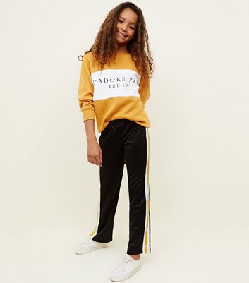 black joggers with yellow side stripe