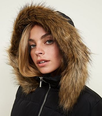 black puffer jacket with brown fur hood