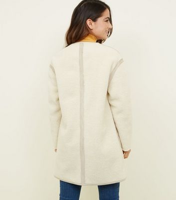 cream collarless coat