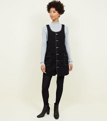 pinafore dress with tights and boots