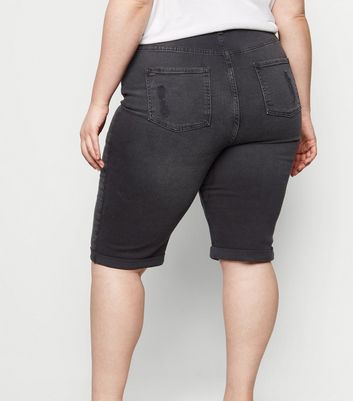 black ripped knee shorts