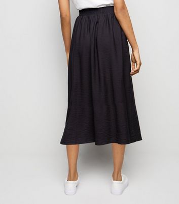 the iconic black a line skirt