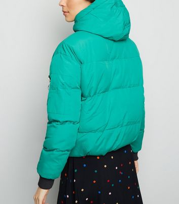 green hooded puffer jacket