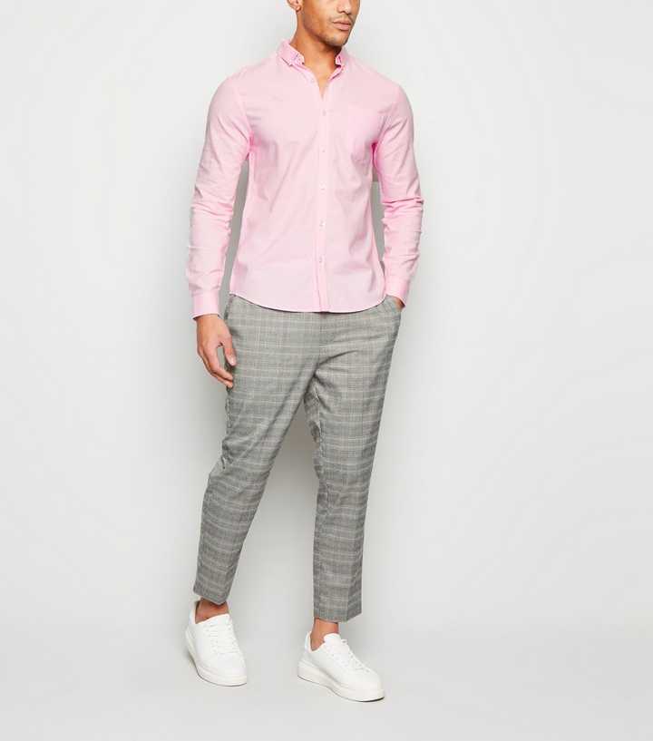 pink shirt and grey trousers