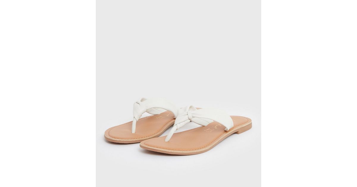 white leather flip flops