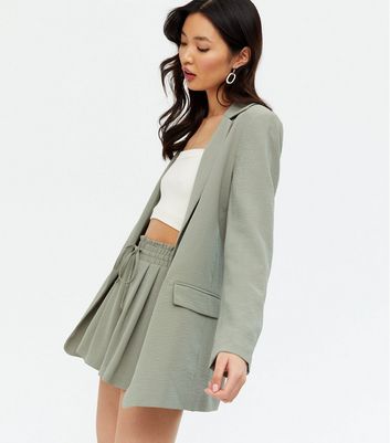 sage green blazer and shorts