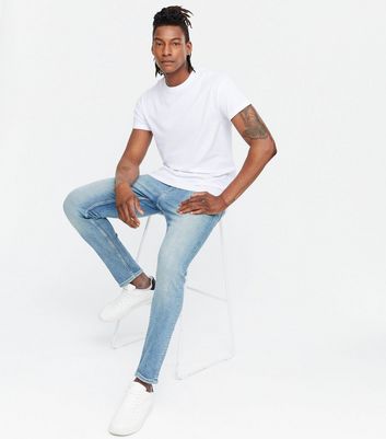 Washed blue jeans store with white shirt