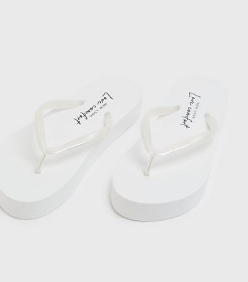 white chunky flip flops