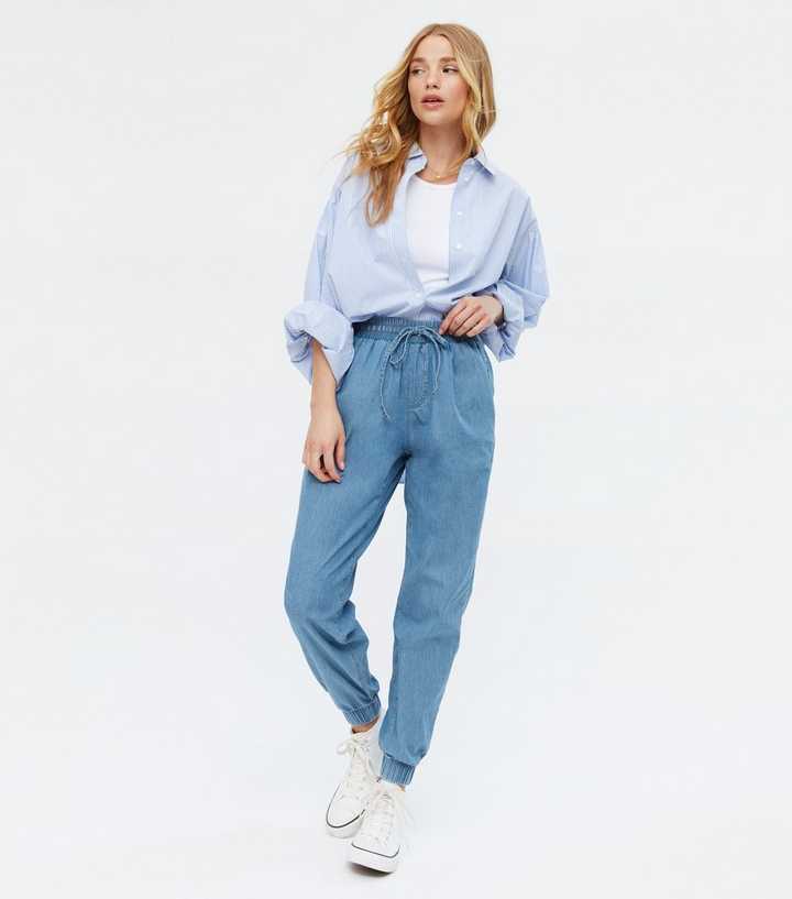 https://media3.newlookassets.com/i/newlook/688736240/womens/clothing/jeans/blue-tie-waist-jogger-jeans.jpg?strip=true&qlt=50&w=720