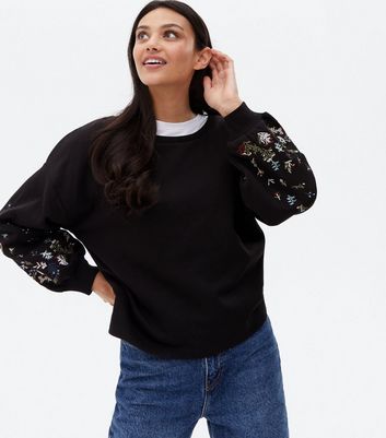 Black sweater shop with embroidered flowers