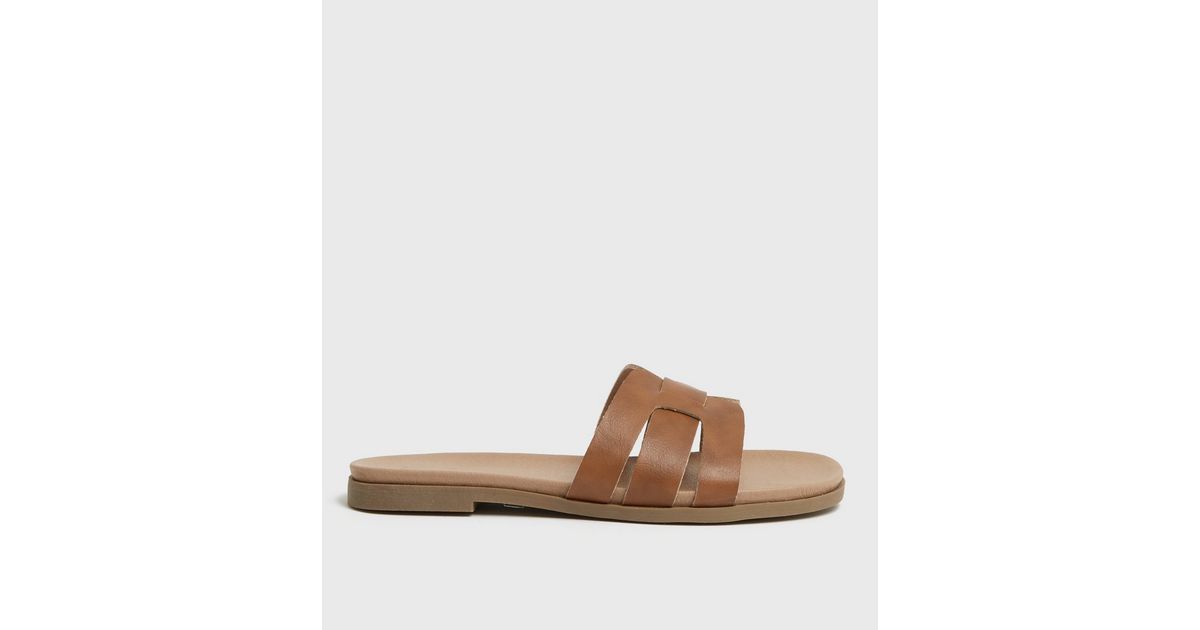 tan cross strap sliders