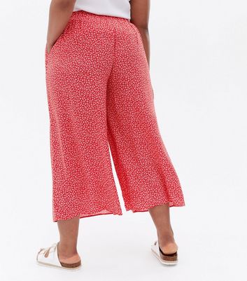 Click to view product details and reviews for Curves Red Ditsy Floral Wide Leg Crop Trousers New Look.