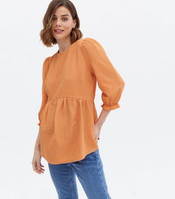 Orange peplum top on sale