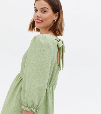 Click to view product details and reviews for Maternity Light Green Textured Tie Back Mini Smock Dress New Look.