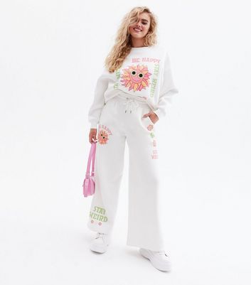 Click to view product details and reviews for Be Happy Stay Weird White Sunflower Logo Joggers New Look.