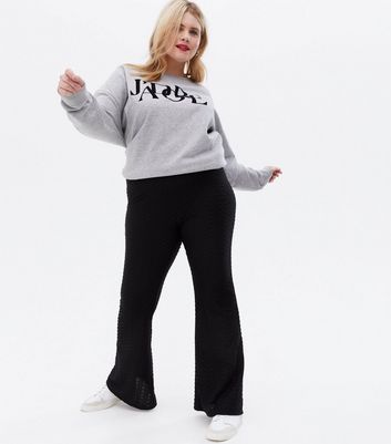 Click to view product details and reviews for Curves Black Textured Flared Trousers New Look.