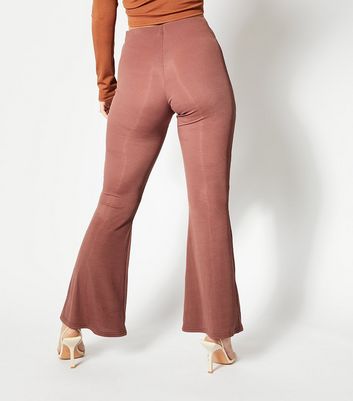 Click to view product details and reviews for Skinnydip Rust Ribbed Cut Out Ring Flared Trousers New Look.