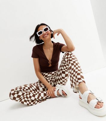 Click to view product details and reviews for Brown Checkerboard Flared Trousers New Look.