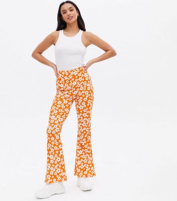 Click to view product details and reviews for Petite Orange Floral Crinkle Jersey Flared Trousers New Look.