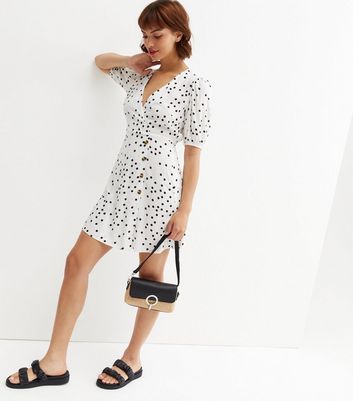 Click to view product details and reviews for White Spot Side Button Mini Wrap Dress New Look.