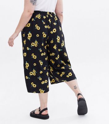 Click to view product details and reviews for Curves Black Sunflower Crop Wide Leg Trousers New Look.