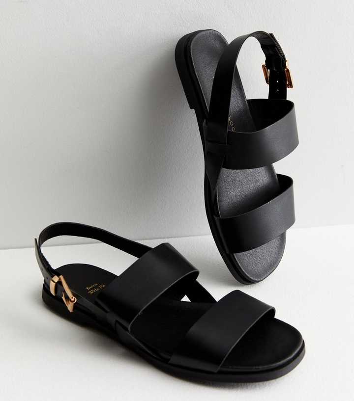 https://media3.newlookassets.com/i/newlook/852913201/womens/footwear/shoes/extra-wide-fit-black-leather-look-footbed-sandals.jpg?strip=true&qlt=50&w=720