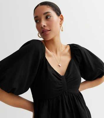 Black Puff Sleeve Tie Back Peplum Top