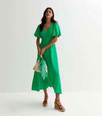 Green dress shop with buttons