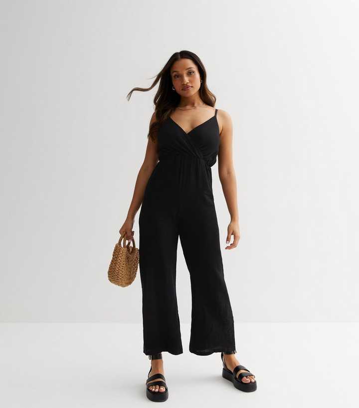 https://media3.newlookassets.com/i/newlook/867940301/womens/clothing/playsuits-jumpsuits/petite-black-strappy-wrap-jumpsuit.jpg?strip=true&qlt=50&w=720