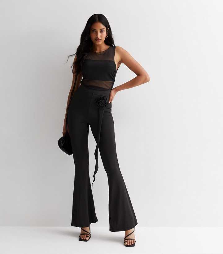 https://media3.newlookassets.com/i/newlook/879723401/womens/clothing/trousers/cameo-rose-black-flower-corsage-flared-trousers.jpg?strip=true&qlt=50&w=720