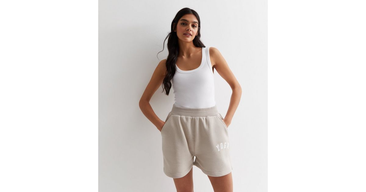 https://media3.newlookassets.com/i/newlook/892578316/womens/clothing/shorts/pink-vanilla-stone-jersey-yoga-logo-shorts.jpg?w=1200&h=630