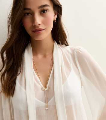 Gold Tone Faux Pearl Charm Bow Long Necklace