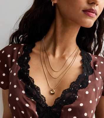 Gold Tone Triple Layer Oval Pendant Necklace