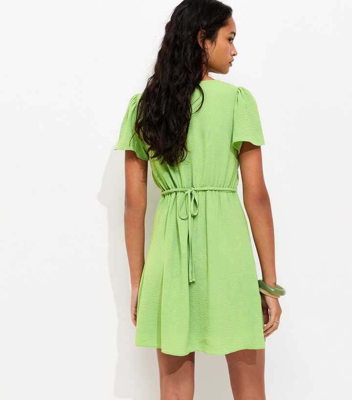 green emerald velvet dress Una Embroidered Cotton Light Green Midi Tea Dress – Finery London main image 0